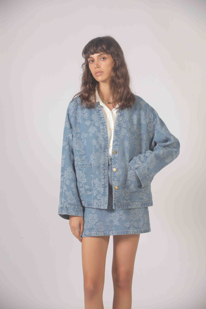 Freeflower embroidered denim jacket by The Korner featuring detailed floral embroidery on a classic blue denim jacket.