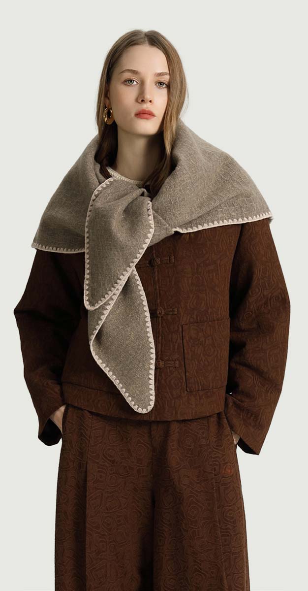 Marise Knit Triangle Scarf in neutral tones, featuring soft knitted fabric and stylish triangular design by The Korner.