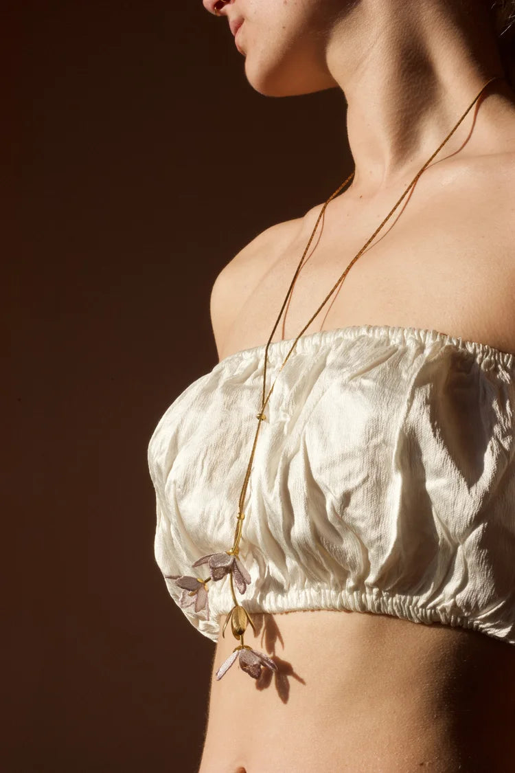 Tahitian Gardenia Flower Necklace by Ilk Jewelry featuring a delicate flower pendant in vintage lace on a fine chain.