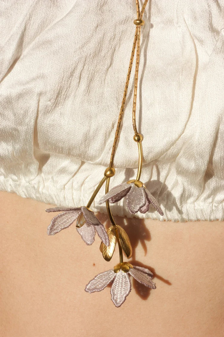 Tahitian Gardenia flower necklace by Ilk Jewelry featuring a delicate floral pendant in vintage lace  on a gold chain.