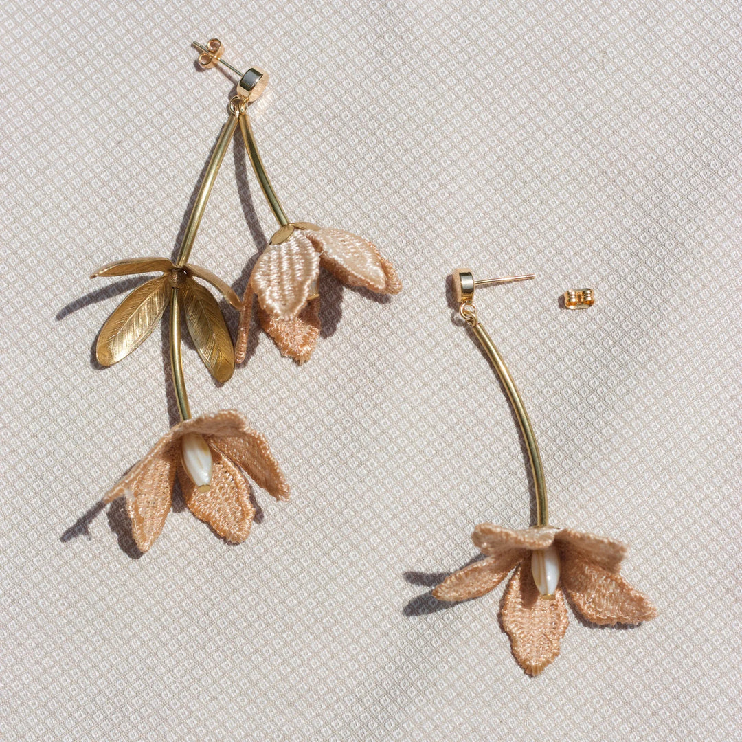 Tahitian Gardenia flower earring by Ilk Jewelry featuring a delicate floral design in vintage lace  and elegant gold setting.