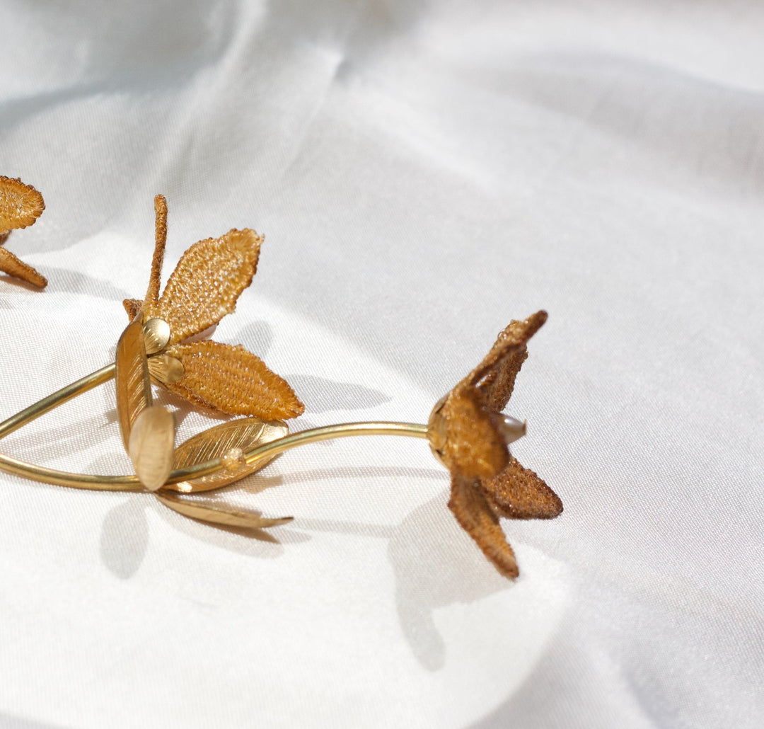 Tahitian gardenia flower necklace by Ilk Jewelry featuring a vibrant mustard ochre pendant on a delicate chain.