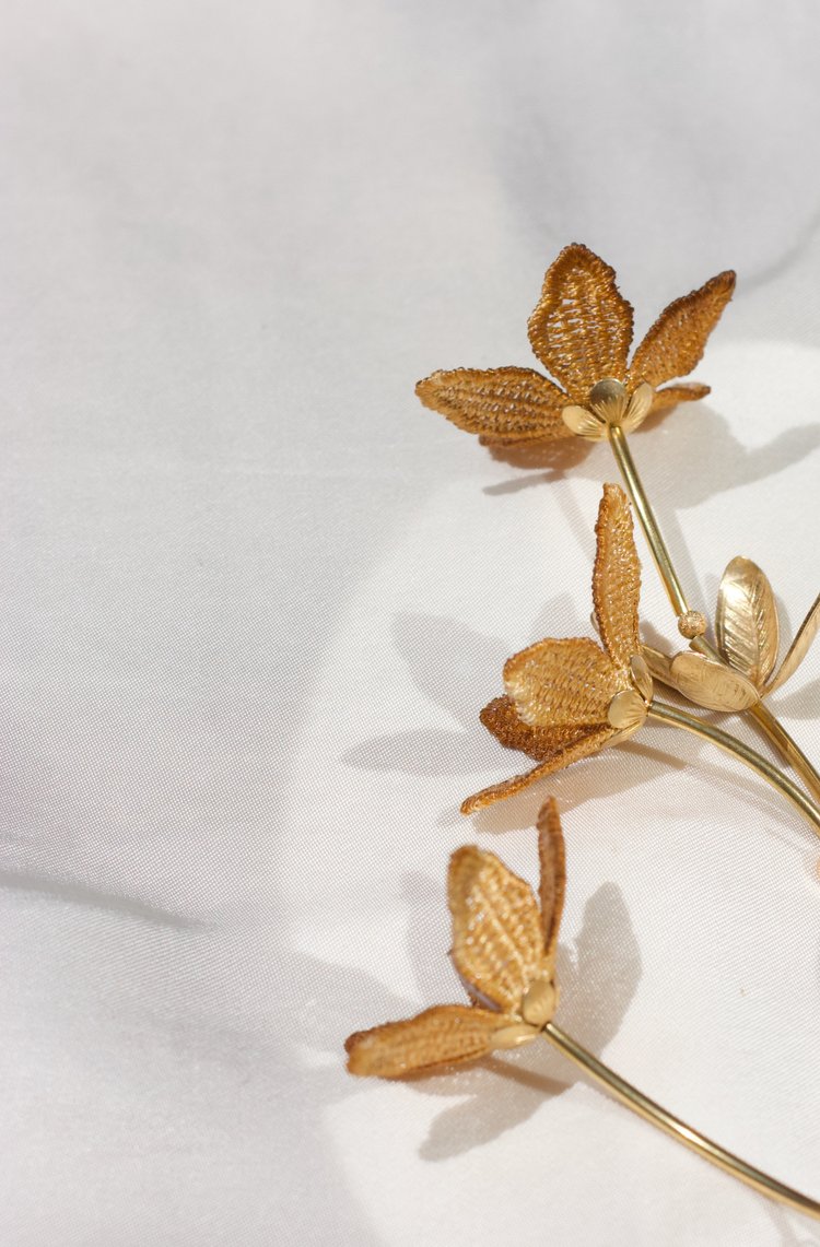 Tahitian Gardenia Flower necklace by Ilk Jewelry featuring a mustard ochre flower pendant on a delicate chain.