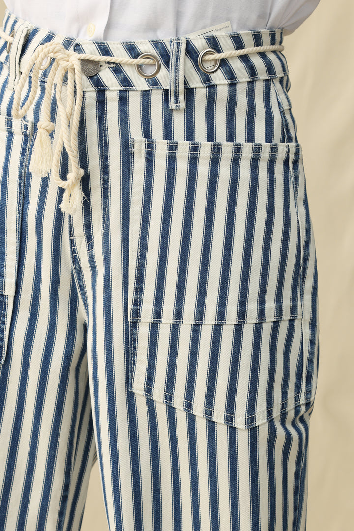 Blue and white striped pants with a drawstring waistband on a beige background