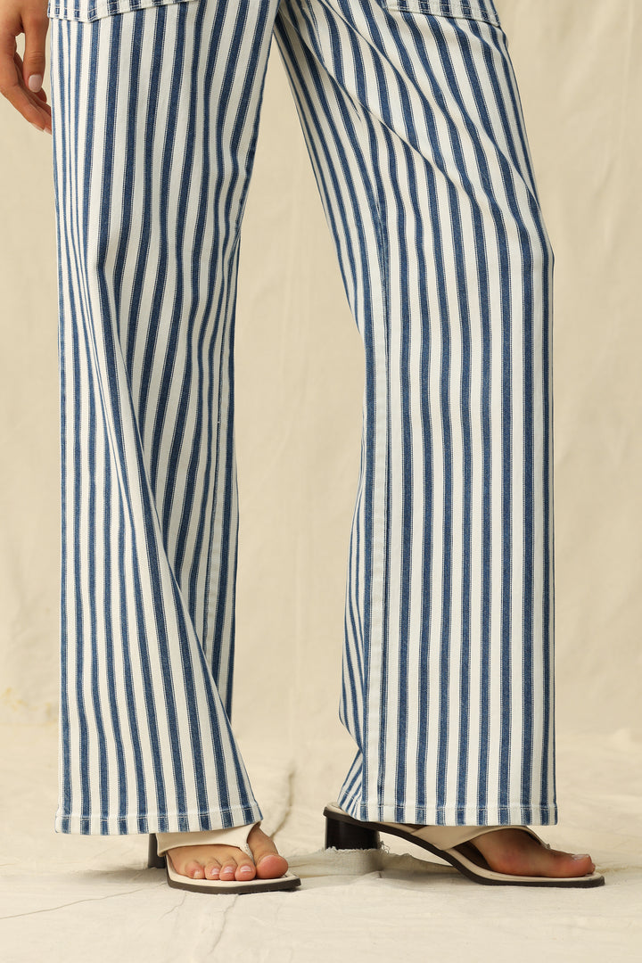 Blue and white striped pants worn by a person on a plain background