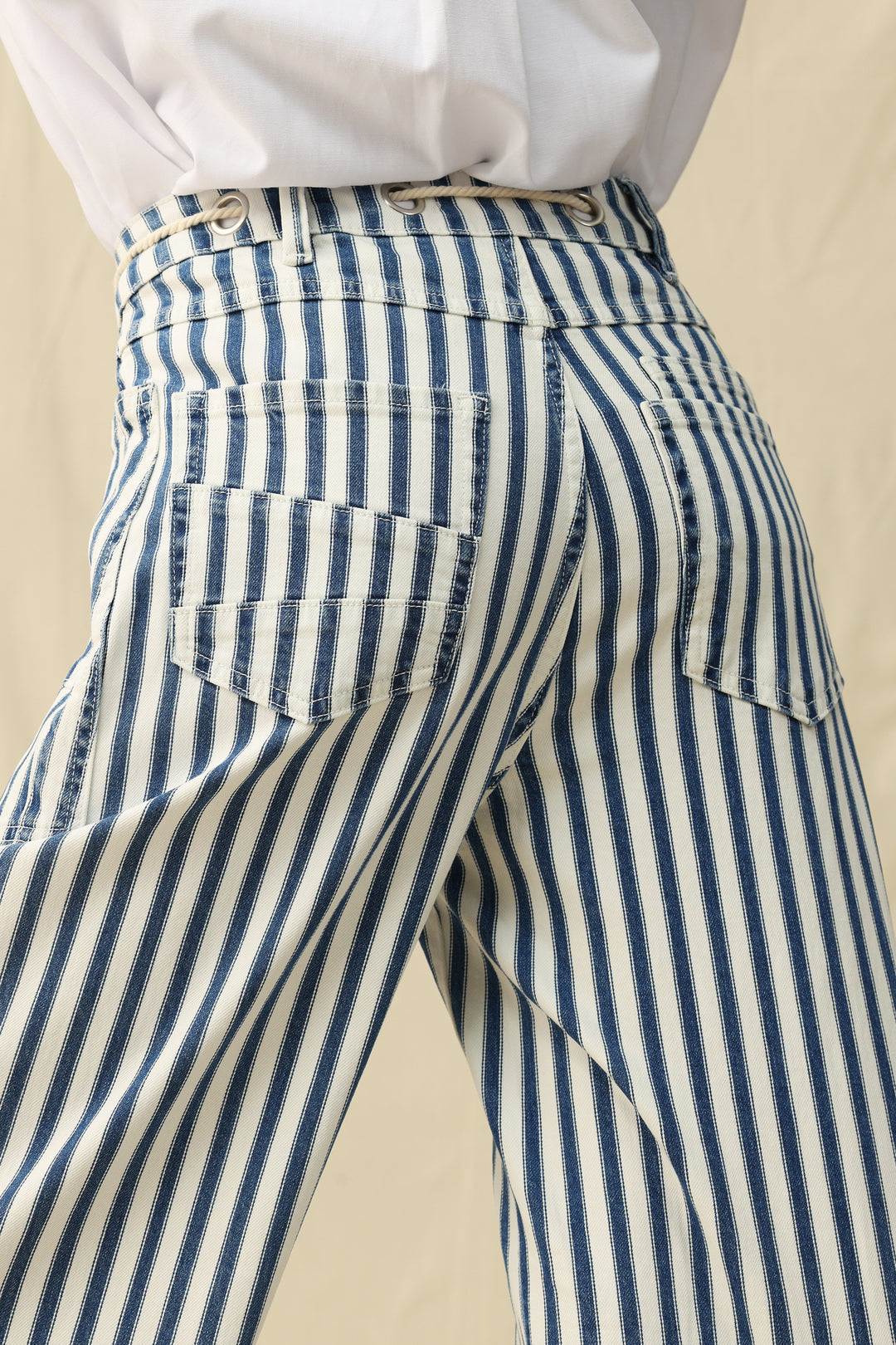 Blue and white striped pants with a beige background