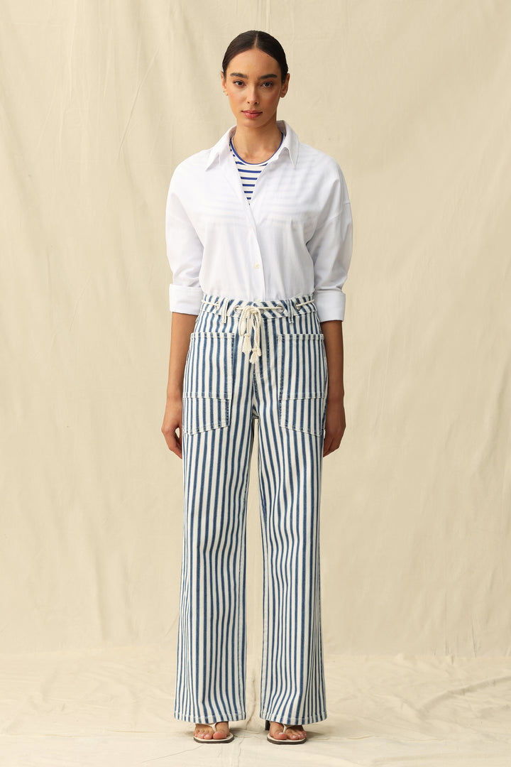Woman in Tamsin Rail Stripe Wide Leg Jeans by Bayeas, showcasing high-waisted denim with bold stripe details against a neutral backdrop.