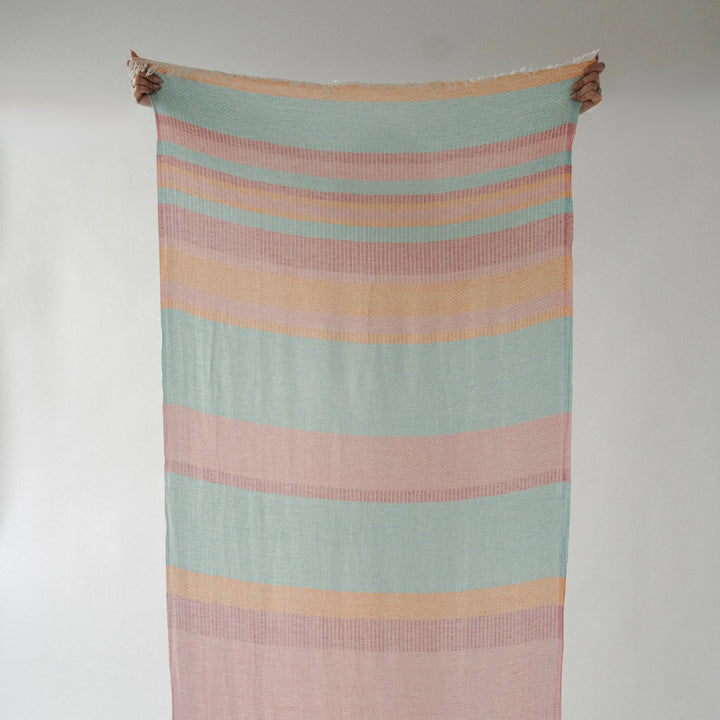 Turkish cotton towel with Teaberry stripe design by Pokoloko, showcasing soft, absorbent fabric and vibrant striped pattern.