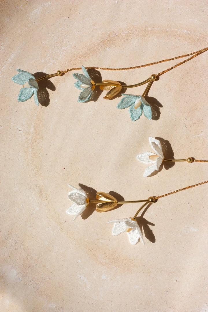Tahitian Gardenia Flower Necklace by Ilk Jewelry featuring a delicate floral pendant in vintage lace  on a fine gold chain.