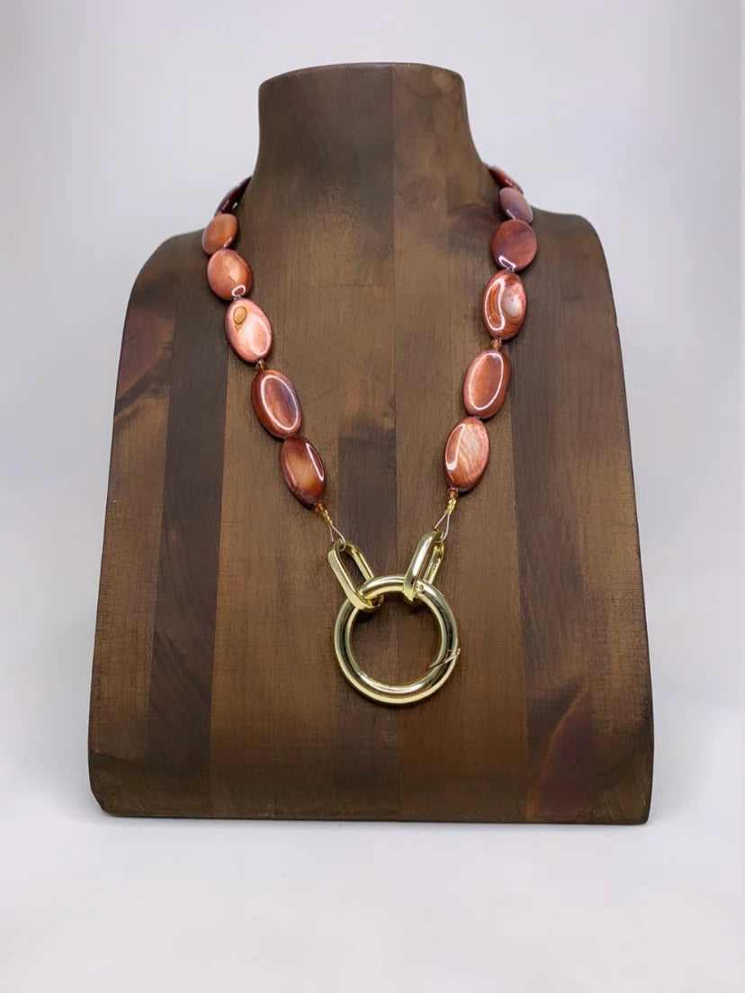 Lofttan Trent oyster shell necklace featuring a red shell pendant on a delicate chain, elegant jewelry for casual or formal wear.