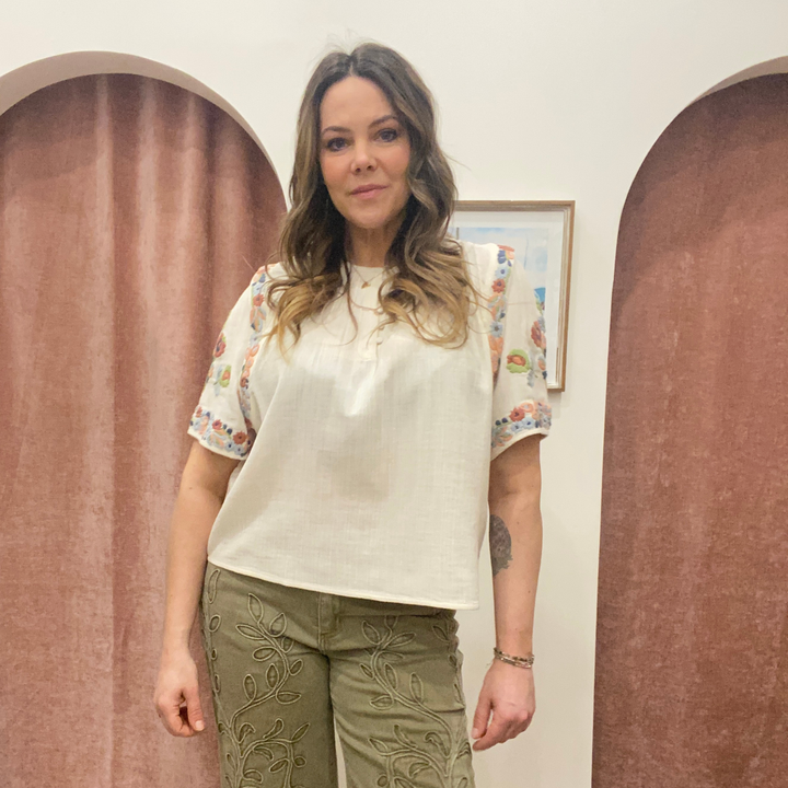Louizon badge embroidered blouse top with detailed floral embroidery and relaxed fit, perfect for casual or semi-formal wear.