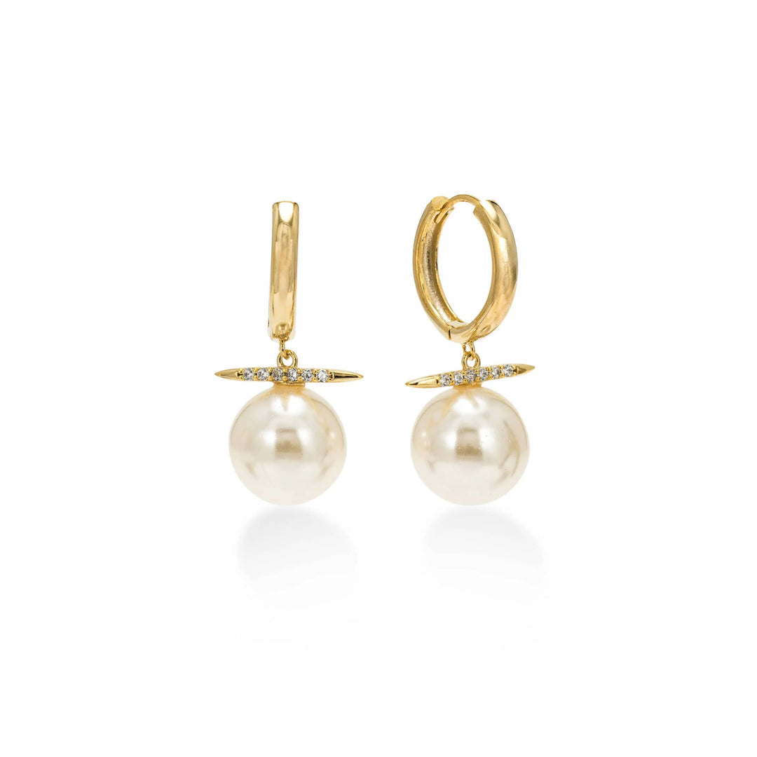 Gold hoop earrings with pearl drops on a white background