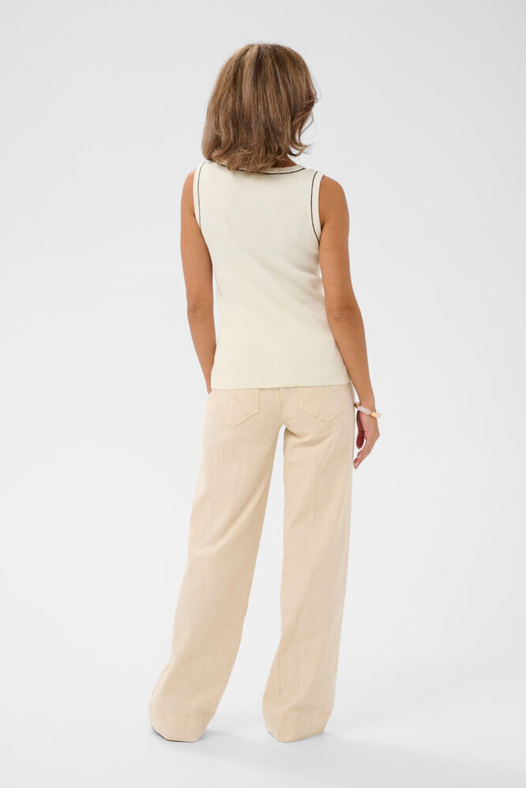 Cream Vilea ribbed knit tank top featuring a fitted sleeveless design with a scoop neckline and textured ribbed fabric.