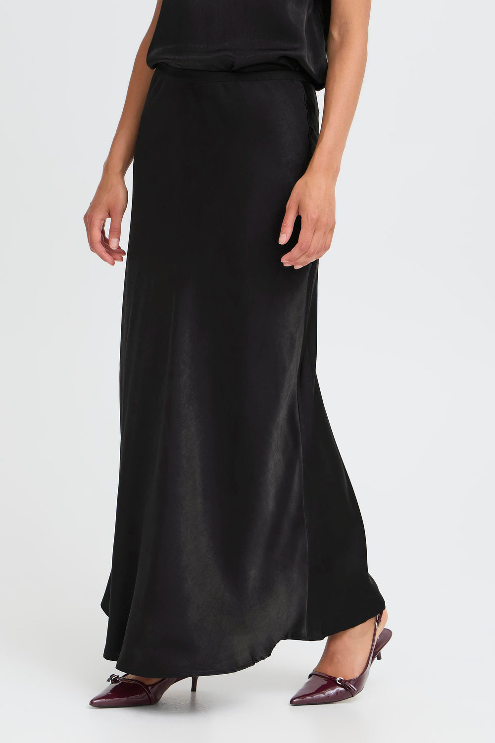 Person wearing a black skirt on a white background