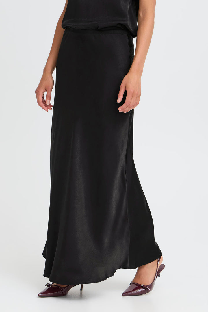 Person wearing a black skirt on a white background