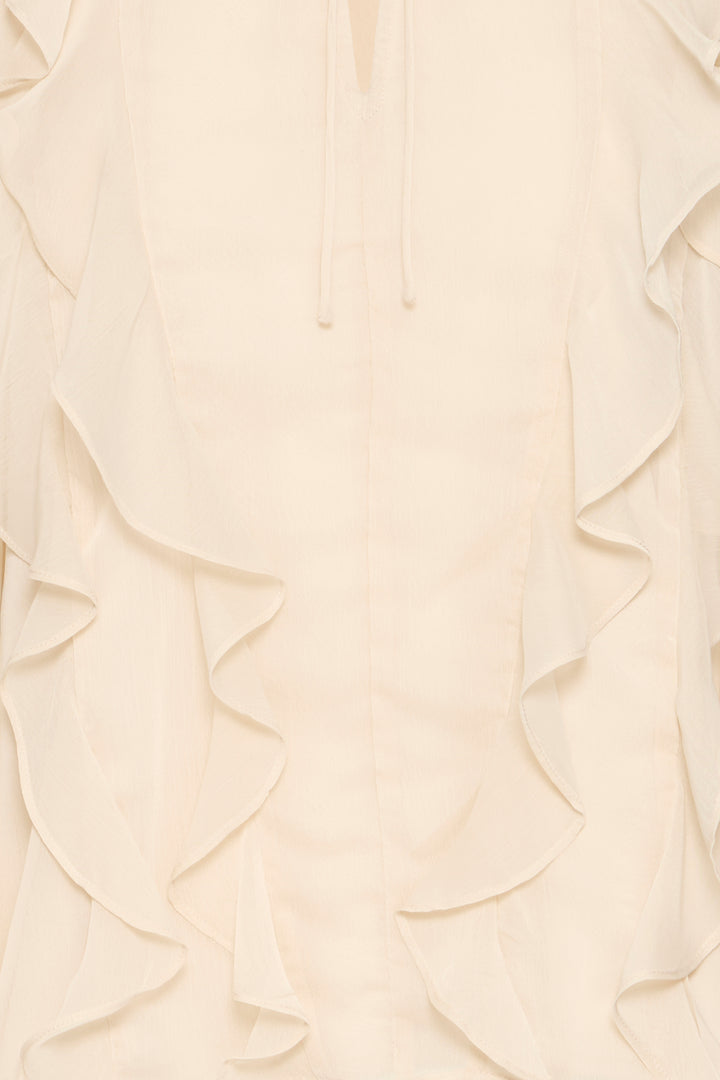 Close-up of a cream-colored fabric with ruffled texture