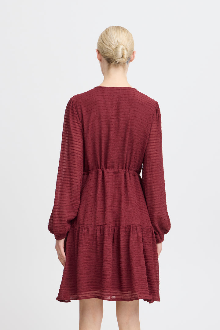 Maroon dress worn by a person on a white background