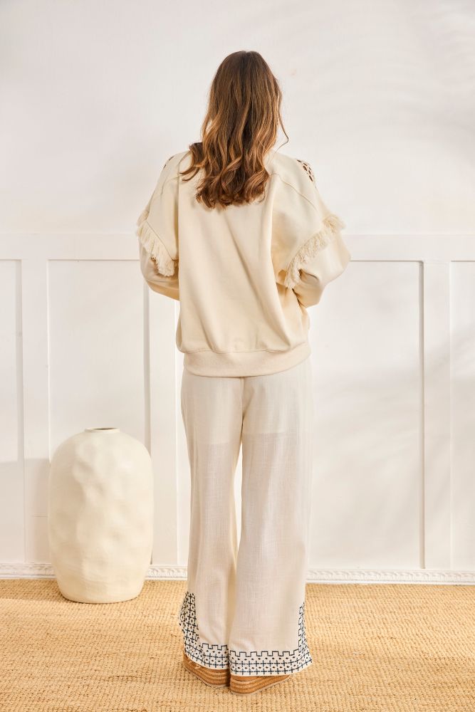 NKN by Nekane Zuno Fringe Sweatshirt, a cozy sweater with stylish boho fringe details, shown in a relaxed fit on a model.