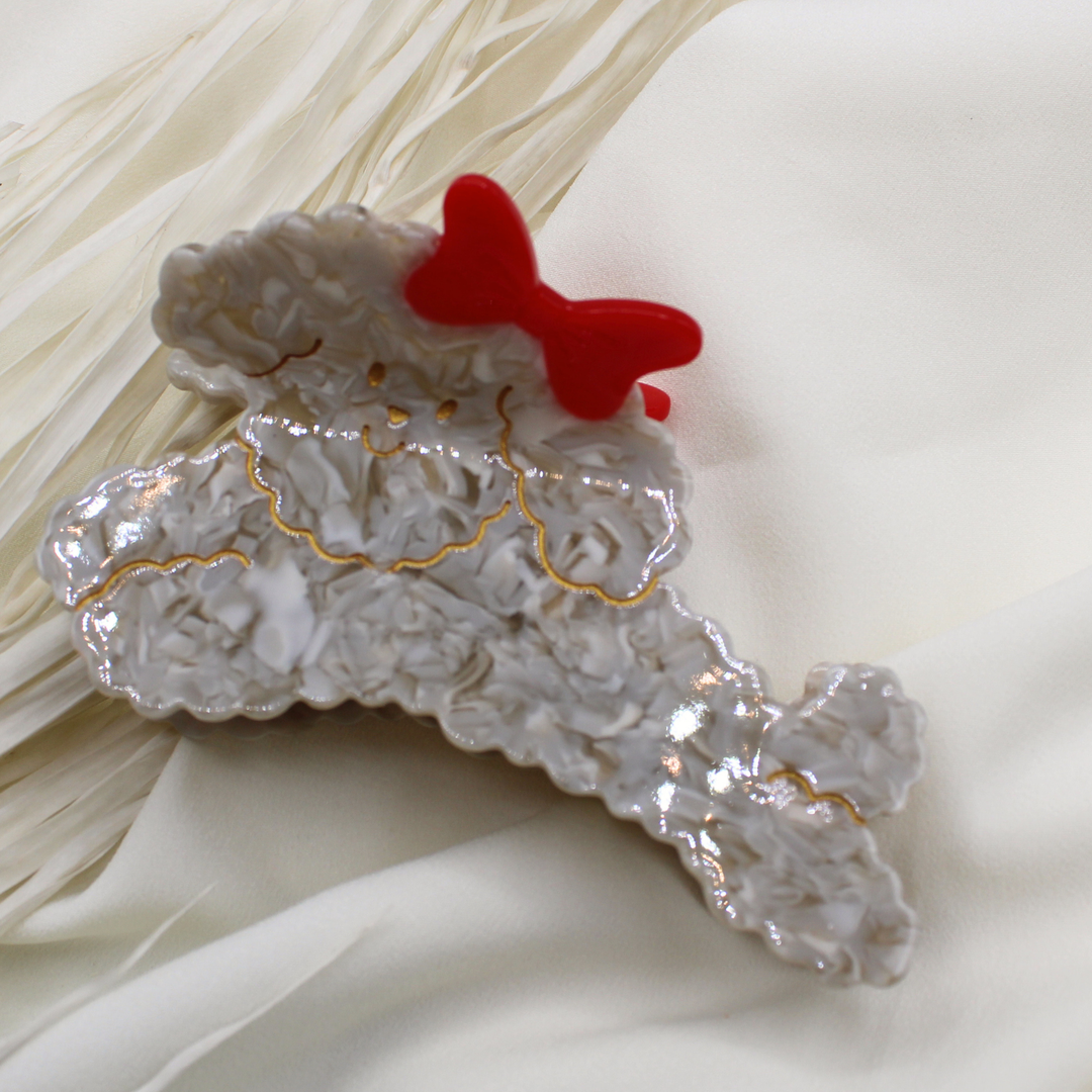 grey fluffy dog poodle labradoodle claw clip hair accessory hair clip cute dog red bow in hair