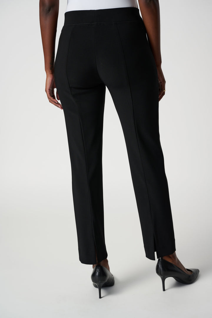 Black pants worn by a person on a white background