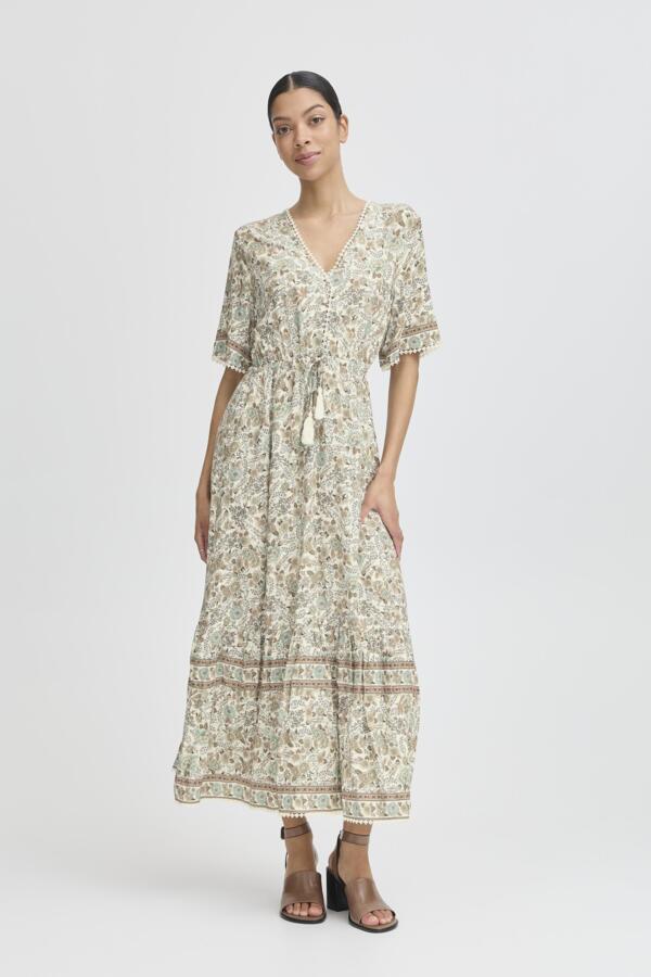 light green, beige and cream boho floral  maxi dress with tassel tie at waist and embroidered trim at v neckline. 