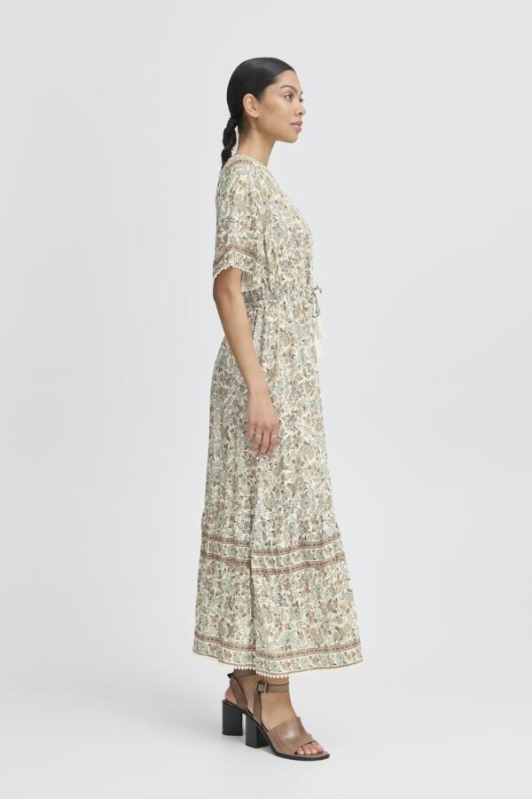 light green, beige and cream boho floral  maxi dress with tassel tie at waist and embroidered trim at v neckline. 