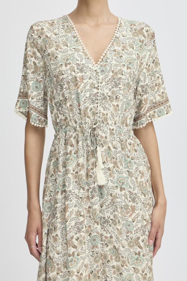 light green, beige and cream boho floral  maxi dress with tassel tie at waist and embroidered trim at v neckline. 