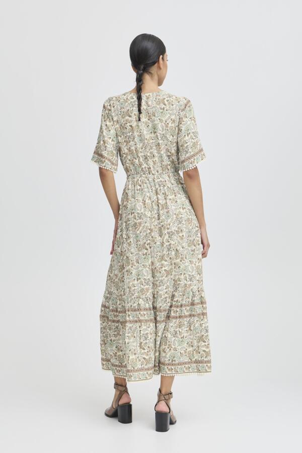 light green, beige and cream boho floral  maxi dress with tassel tie at waist and embroidered trim at v neckline. 