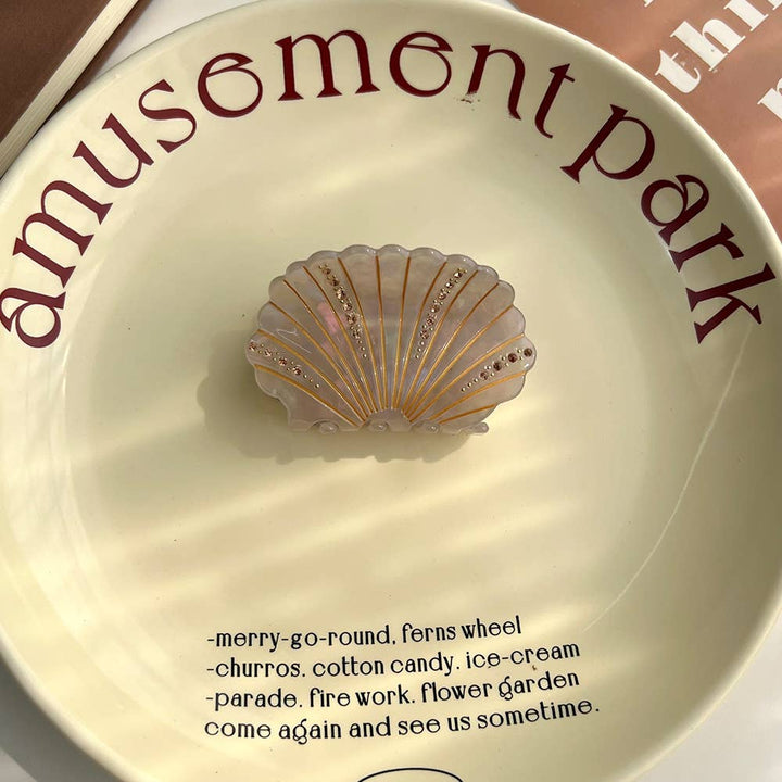 LadyJuneAccessories sea shell claw clip with decorative shell design, perfect for securing hair in a stylish, beach-inspired look.